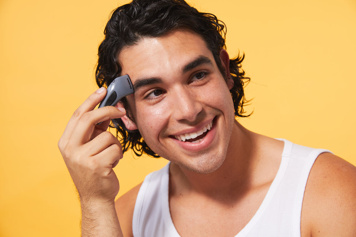 An image of a man using a blue light therapy device for breakouts