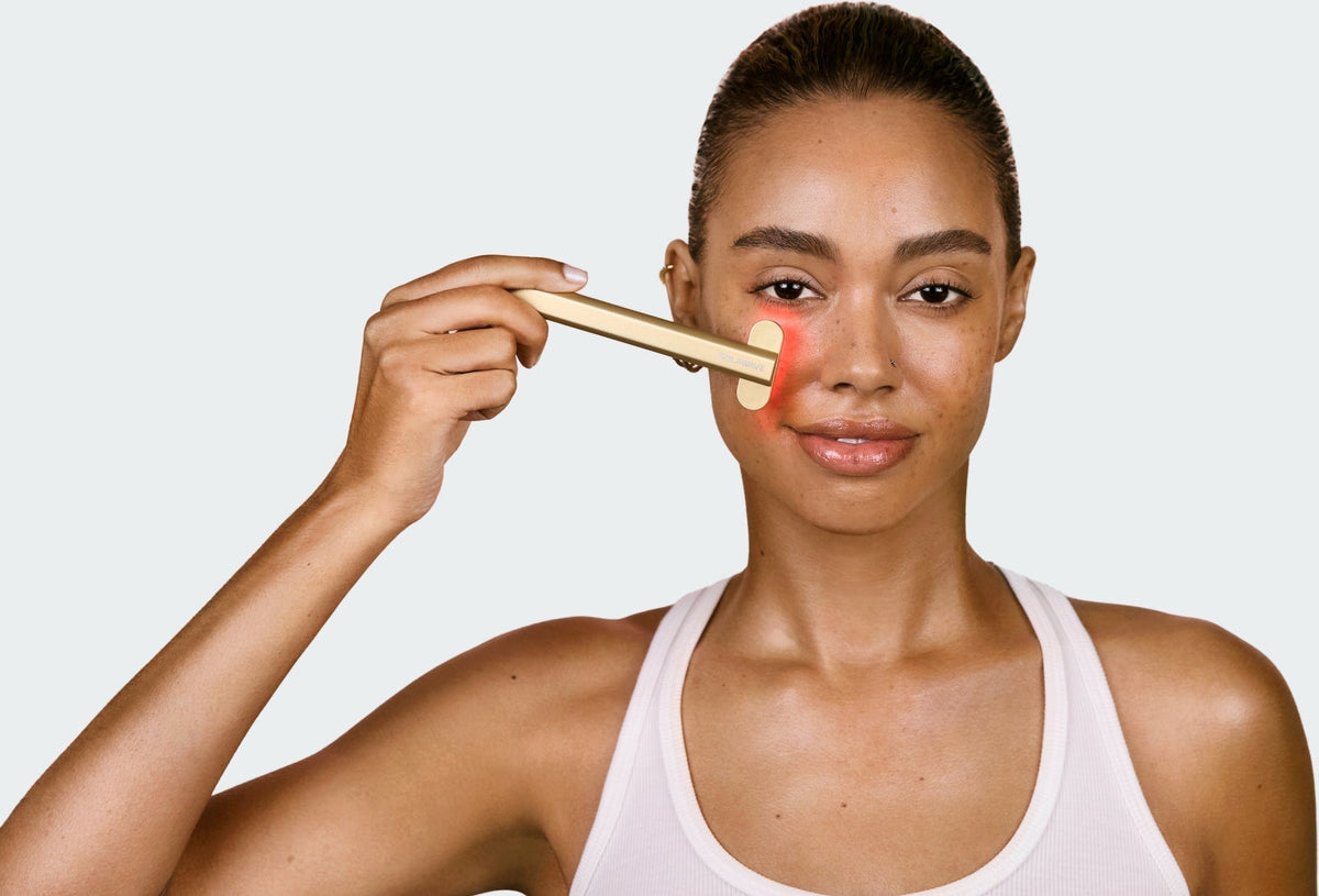 An image of a woman using a red light therapy wand with galvanic current