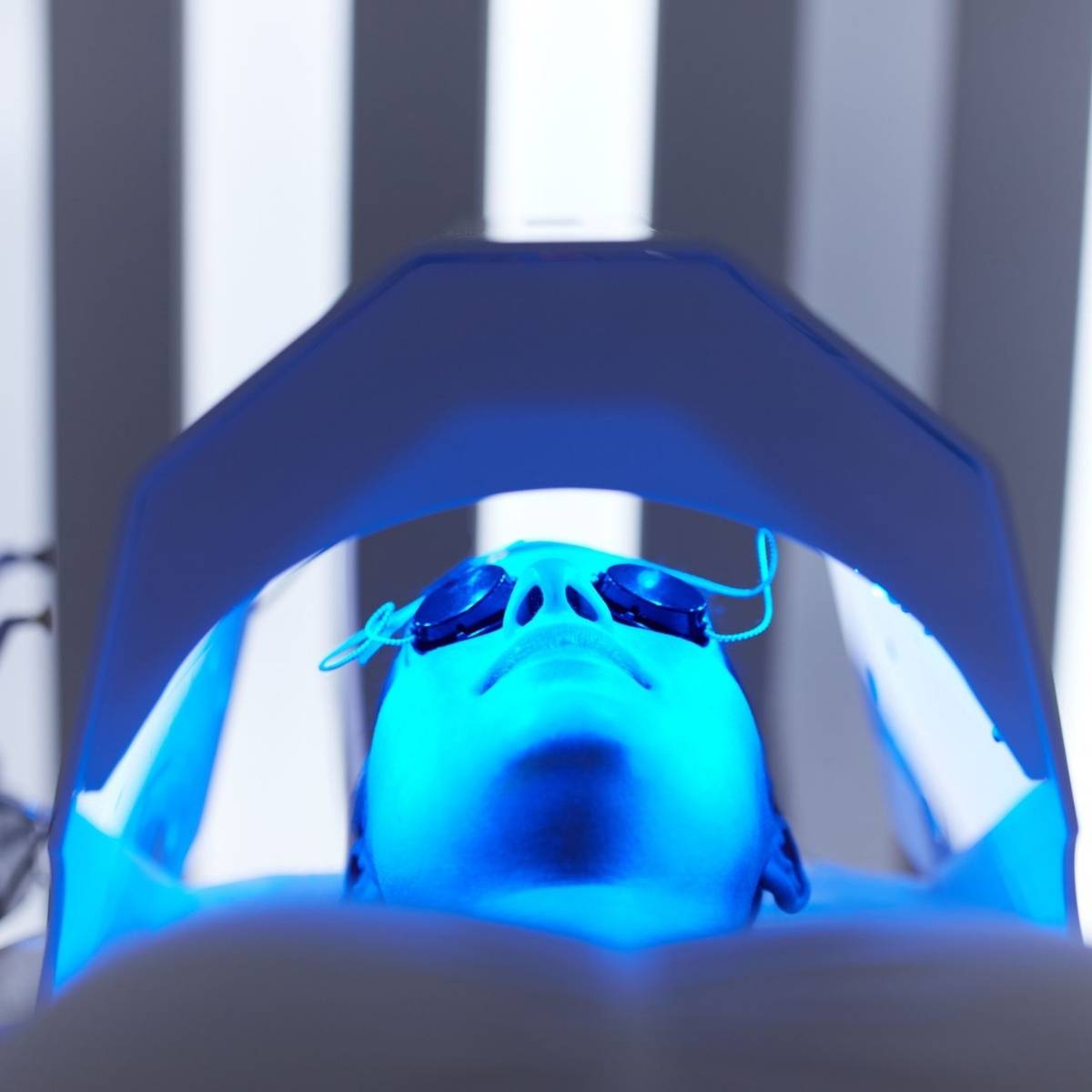 An image of someone laying down getting blue light therapy treatment