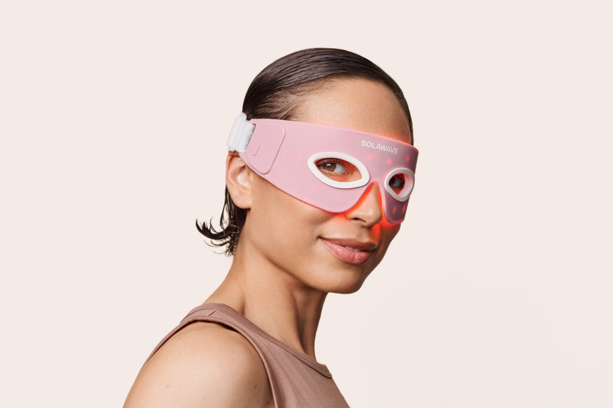 An image of a woman wearing a red light therapy eye mask