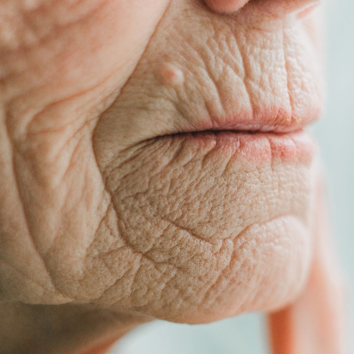 A persons face with lots of face wrinkles