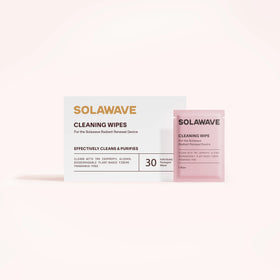 A white Solawave Light Therapy Device Cleaning Wipes box sits by a pink packet. The box features 30 biodegradable, alcohol-free, plant-based, and fragrance-free wipes for gentle, eco-friendly cleaning.