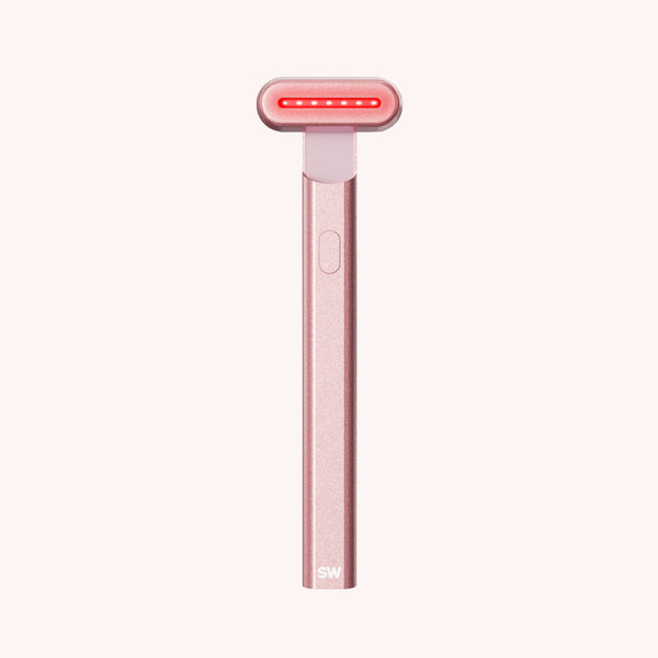 Rose gold handheld device with red light on a white background || Rose Gold